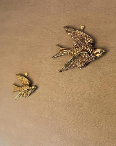 two birds earrings are hanging on a wall at fleuve tenmonkan in Yamashitachō