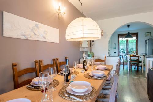 a dining room with a wooden table and chairs at Home Sweet Home Garden & Lake View - Happy Rentals in Besozzo