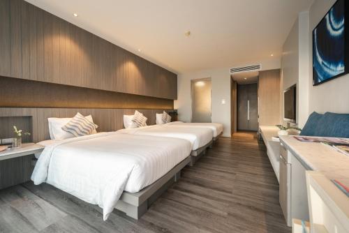 a bedroom with two large beds in a room at Hotel IKON Phuket - SHA Extra Plus in Karon Beach