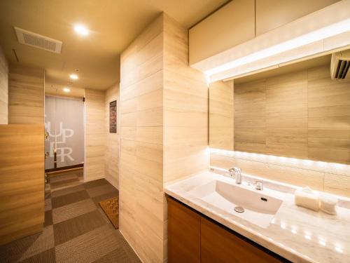 a bathroom with a sink and a mirror at Super Hotel Sapporo Susukino in Sapporo