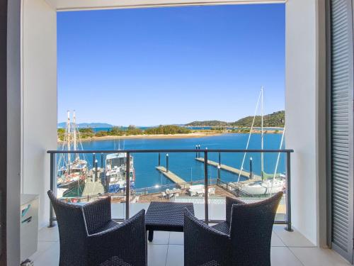 a balcony with a view of a marina at Blue on Blue Studio Room 1362 in Nelly Bay