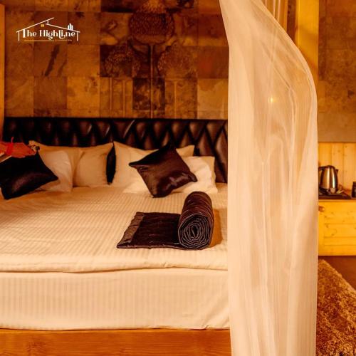 a white bed with a veil on top of it at The Highline luxurious stay in Kodaikānāl