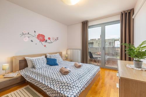 a bedroom with a bed and a large window at Deluxe Apartment Marina with a private parking in Rijeka