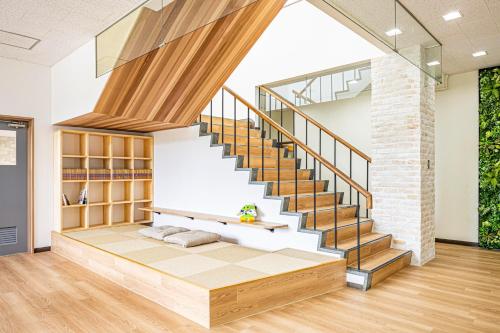 a staircase in a house with a bench under it at Guesthouse Sunaen - Vacation STAY 49055v in Tottori