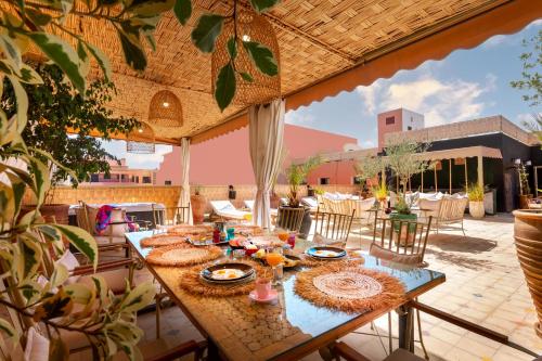 a patio with a table with food on it at LES TANNEURS PENTHOUSE MARRAKECH in Marrakesh