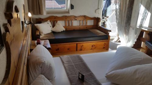 a bedroom with two beds and a window at Alp Art Hotel Götzens in Innsbruck