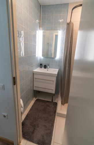 a bathroom with a sink and a mirror at Nikolai 9 City Centre Apartment in Pärnu