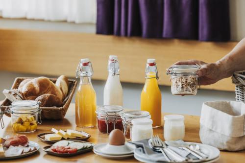 a table with bottles of milk and eggs and bread at Fuxbau in Stuben am Arlberg