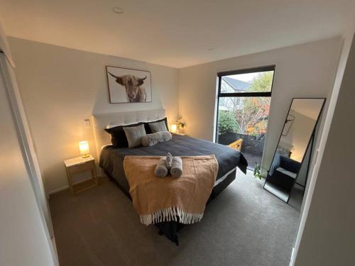 a bedroom with a large bed and a large window at Luxury 2 Bedroom Hideout Near CBD,Merivale Mall in Christchurch