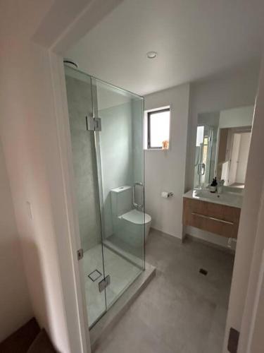 a bathroom with a shower and a toilet and a sink at Luxury 2 Bedroom Hideout Near CBD,Merivale Mall in Christchurch