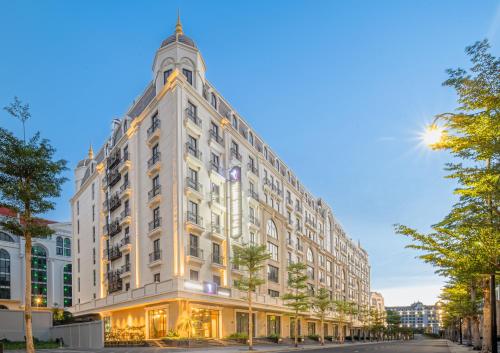 a large white building on a city street at TK Phu Quoc Hotel - Grand World Phu Quoc in Phu Quoc