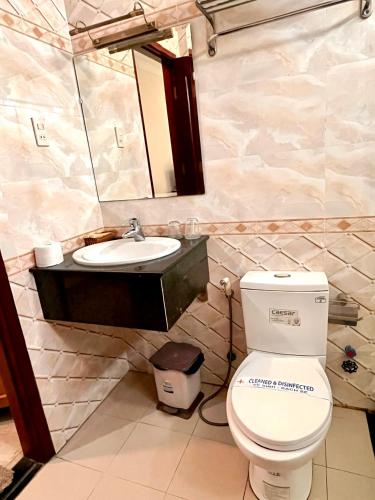 a bathroom with a toilet and a sink at Madella Hotel in Can Tho