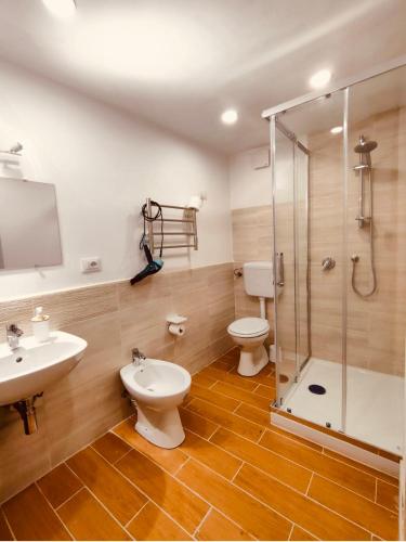 a bathroom with a toilet and a sink and a shower at Normanni Central House in Palermo