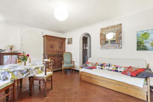 a bedroom with a bed and a table and chairs at Appartement climatisé au Lavandou in Le Lavandou