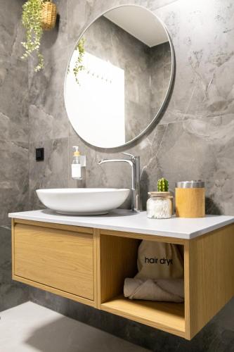 a bathroom with a sink and a mirror at SI apartments - Smart Inn in Vienna