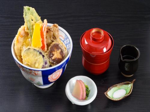 a bowl of food sitting on top of a table at Shin Furano Prince Hotel in Furano