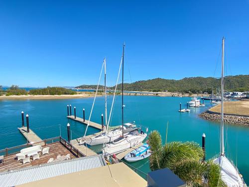 a group of boats docked at a marina at Blue on Blue Apartment 1361 in Nelly Bay