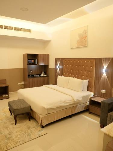 a bedroom with a large bed in a room at Dream Point Hotel in Fujairah