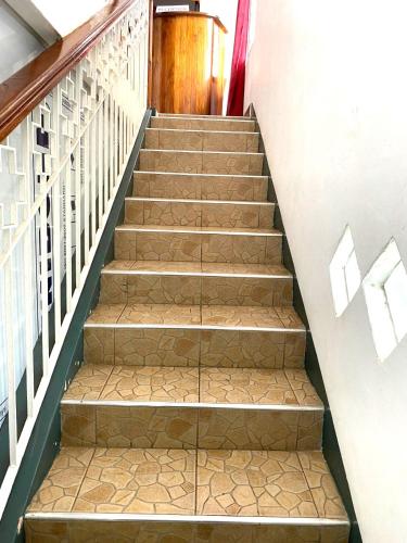 a set of stairs with brown tiles on them at MercuryFM 109 Guest House - Jaffna Temple road 77 in Jaffna