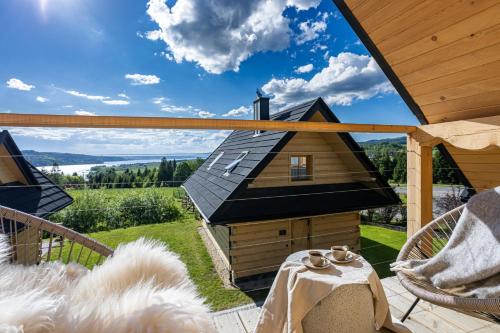 a view from the deck of a house with a roof at Osada Przystanek Czorsztyn in Czorsztyn