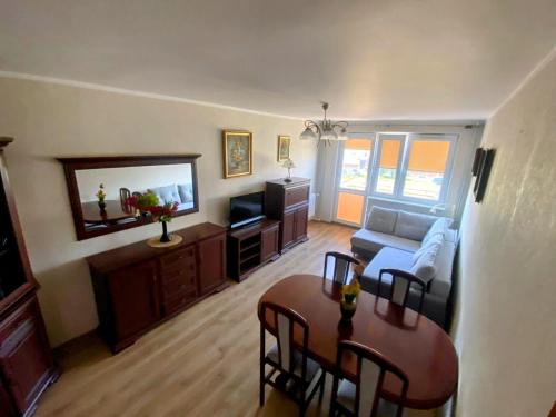 a living room with a couch and a table at Wakacyjny apartament in Hel