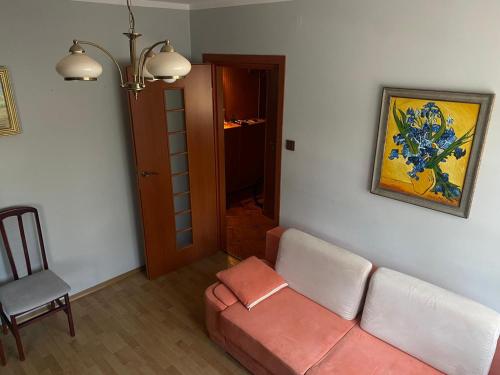 a living room with a couch and a chair at Wakacyjny apartament in Hel