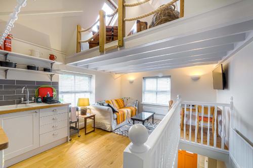 a kitchen and living room with stairs and a living room at Gable End in Arundel