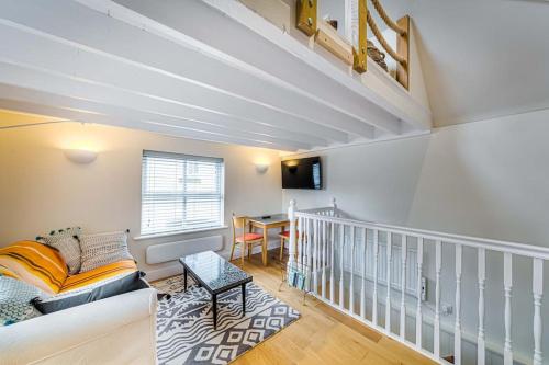 a living room with a couch and a table at Gable End in Arundel