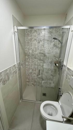 a bathroom with a shower and a toilet at La Zagara Bibione, near beach in Bibione