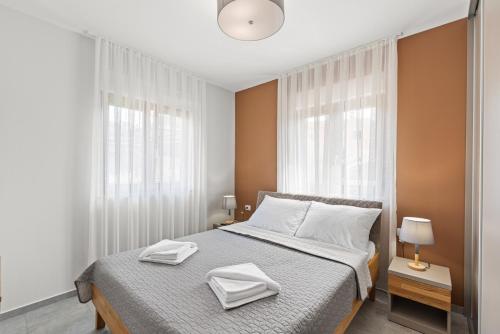 a bedroom with a bed with two towels on it at Villa Ajlin with Private Pool in Sveti Lovreč Pazenatički