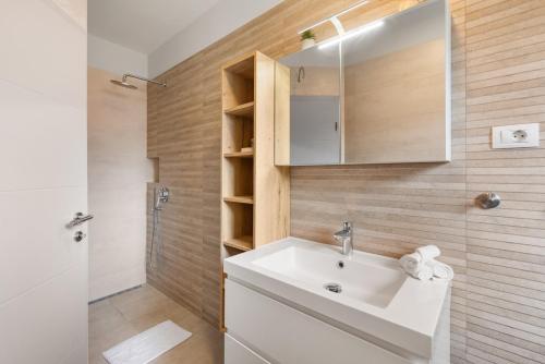 a bathroom with a white sink and a shower at Villa Ajlin with Private Pool in Sveti Lovreč Pazenatički