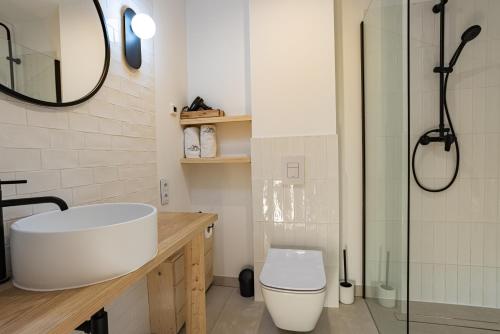 a bathroom with a sink and a toilet and a shower at Osada Przystanek Czorsztyn in Czorsztyn