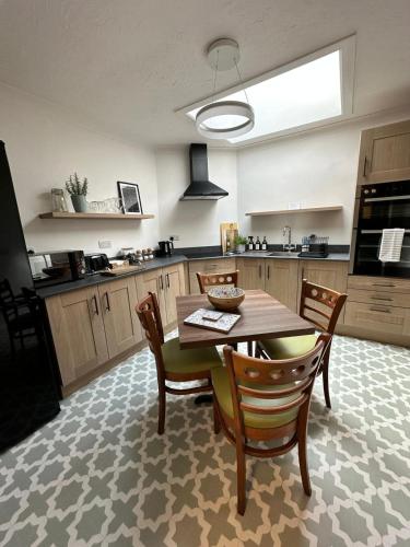 a kitchen with a table and chairs in a kitchen at The Briarcroft in Goole