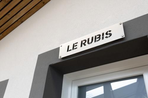 a sign on the side of a building at Studio le Rubis in Éloyes