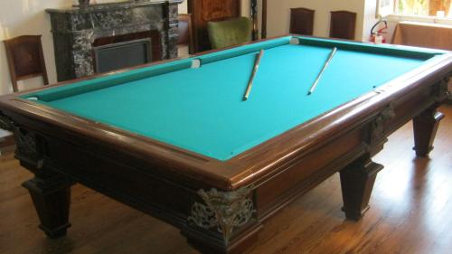 a pool table in a living room with at Hotel Villa Maria in Sanremo