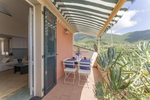 a patio with a table and chairs on a balcony at Emma House Terrace and Sea View Moneglia in Moneglia