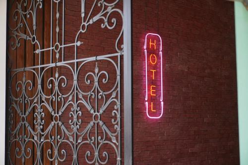 a neon sign on the side of a brick building at Station 22 Hotel in Batumi