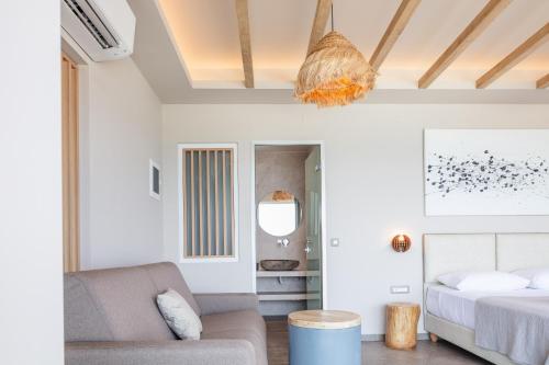 a living room with a bed and a couch at Skipper Beachfront Suites in Hersonissos