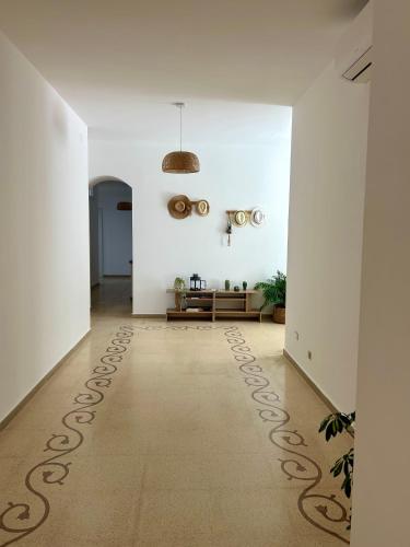 a hallway with white walls and a rug on the floor at Villa Buon Vento in Vignacastrisi