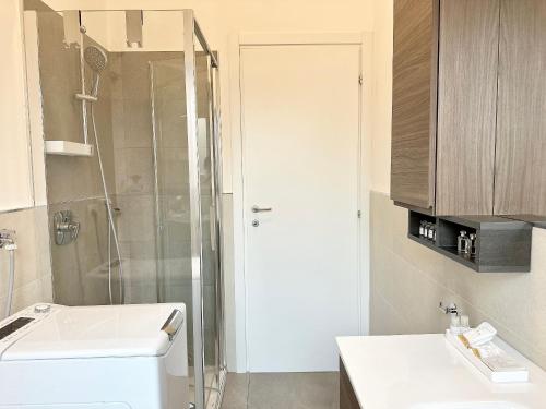a bathroom with a shower and a toilet and a sink at Como Charme Apartment in Como