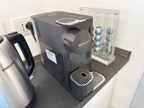 a coffee maker is sitting on a shelf at Como Charme Apartment in Como