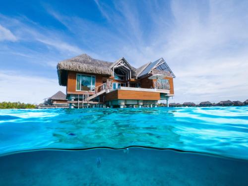 a house over the water in the maldives at InterContinental Bora Bora & Thalasso Spa by IHG in Bora Bora