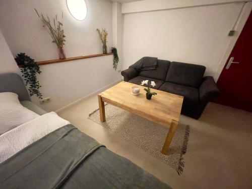 a living room with a couch and a coffee table at Haus Königsee "Terrassenblick" in Bad Oldesloe