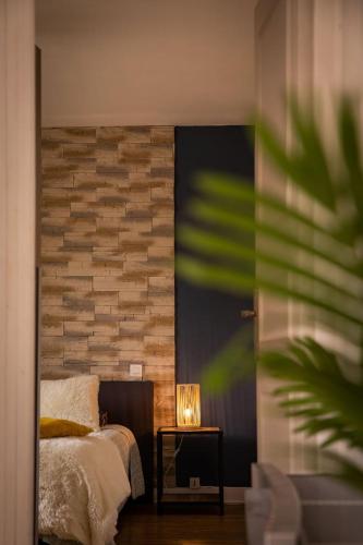 une chambre avec un lit et une table avec une lampe dans l'établissement Le Sarladais - Coeur de Sarlat, à Sarlat-la-Canéda