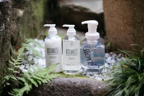 three bottles of water sitting on the ground at Guest House HINATA - Japanese House with Sauna and Open-air Bath in Takayama