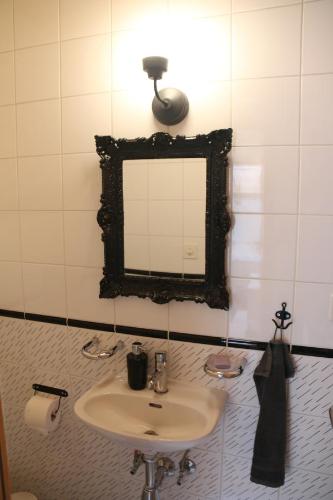 a bathroom with a sink and a mirror at Rodasia in Verbier