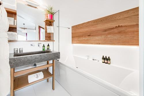 a bathroom with a sink and a mirror at Hotel Pashmina Le Refuge in Val Thorens