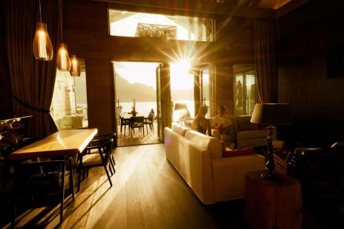 a living room with a couch and a table at InterContinental Bora Bora & Thalasso Spa by IHG in Bora Bora