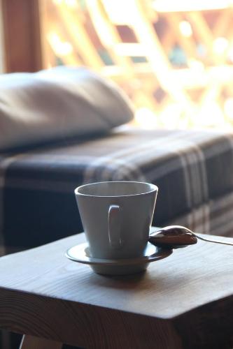 a coffee cup sitting on a table with a spoon at Rodasia in Verbier