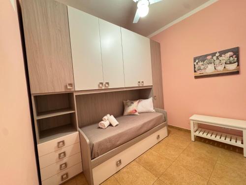 a bedroom with a bed with two stuffed animals on it at A Casa di Mina in Ladispoli